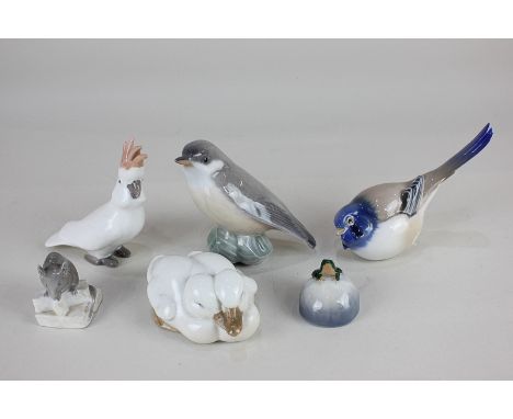 Four Royal Copenhagen porcelain models, a frog on a stone, a mouse on a step, two ducks, and a bird, together with two Bing &