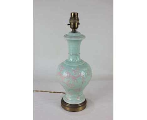 A Chinese Celadon pottery lamp base with pink abstract design of a dragon amongst clouds, 34cm
