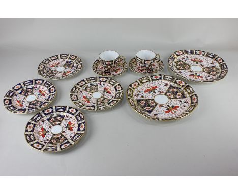 A collection of Royal Crown Derby Imari pattern porcelain, comprising two tea cups and saucers, four side plates and two larg