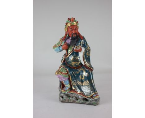 A Chinese porcelain figure of a scholar holding a scroll, with gilt embellishments, 31cm