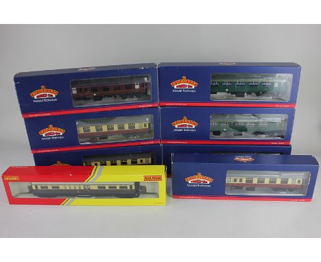 A collection of 00 gauge model railway carriages, seven by Bachmann and one by Hornby in various liveries, used and with asso