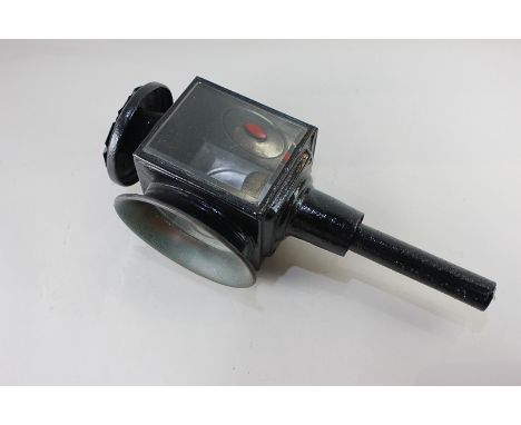 A black painted coach lamp with oval glass front and hinged back, with red glass inset (a/f), 43cm