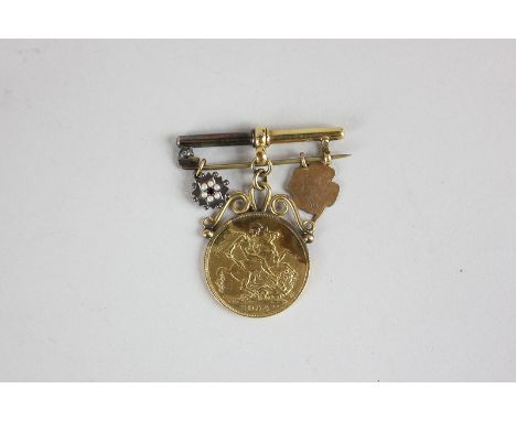 An Edward VII gold sovereign dated 1904, with pierced gold mount, 18ct gold bar, 9ct gold leaf medallion and 15ct gold flower