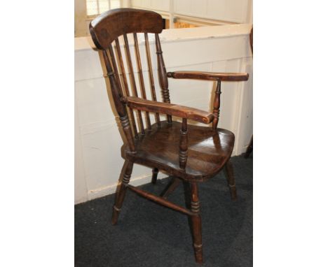 A farmhouse kitchen style stick back armchair with solid elm seat, on turned legs