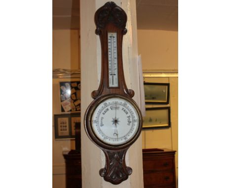 A Victorian wall barometer / thermometer in carved oak case, 82cm, (a/f)