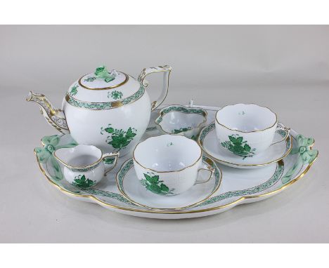 A Herend porcelain cabaret tea set in the green Chinese Bouquet pattern, with teapot, two cups and saucers, milk jug and suga