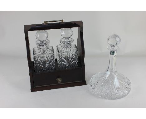 A Thomas Webb crystal ship's decanter, together with a brass bound mahogany tantalus, containing two cut glass decanters, wit