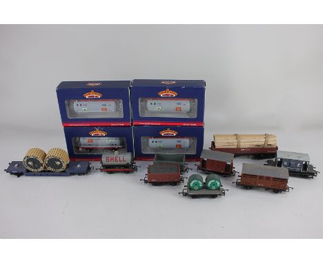 A collection of 00 gauge model railway rolling stock, including four boxed tanker wagons by Bachmann and others loose includi