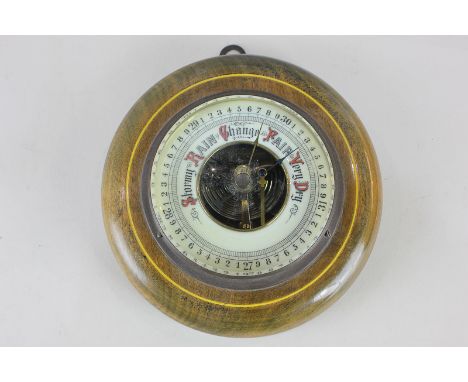 A 19th century circular wall barometer on wooden mount, 17cm