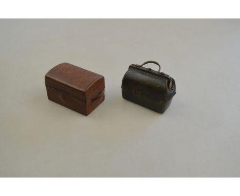 An antique leather covered novelty travelling ink bottle in the form of a Gladstone bag, the hinged cover opening to reveal a