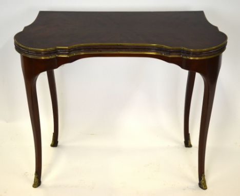 A good quality gilt brass mounted dark satinwood/kingwood card table, the shaped hinge over top baize lined over a double gat