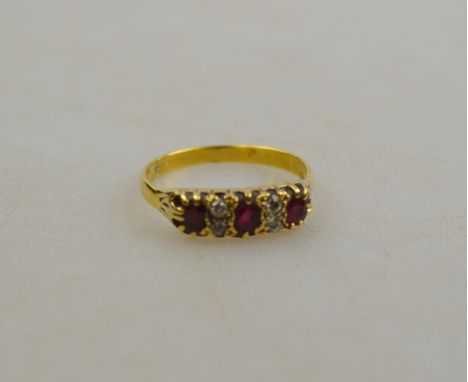 A garnet and old cut diamond seven stone ring, claw set, stamped 18ct