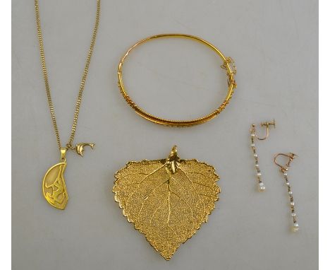 An unmarked gilt metal hinged bangle set with seed pearls, to/w a gold plated leaf pendant, a pair of freshwater pearl drop e