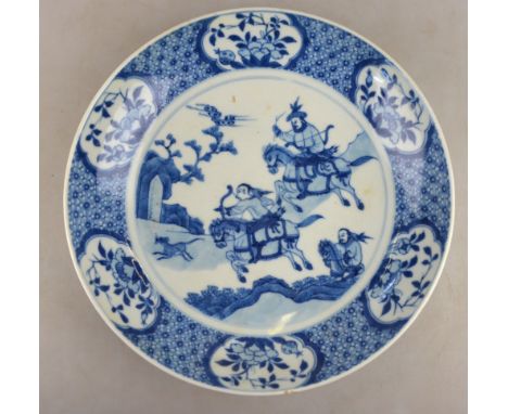 A Chinese early 18th century saucer dish decorated with a hunting scene, conch shell mark, 23 cm to/w a Chinese early 19th ce
