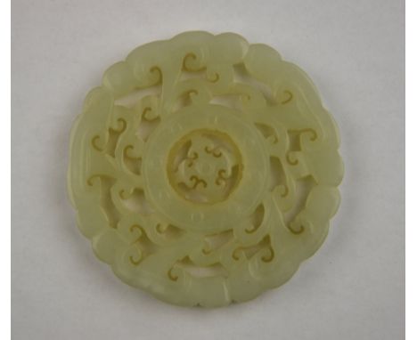 A Chinese later 19th century nephrite jade bi carved with connecting jui, 5.8 cm dia.