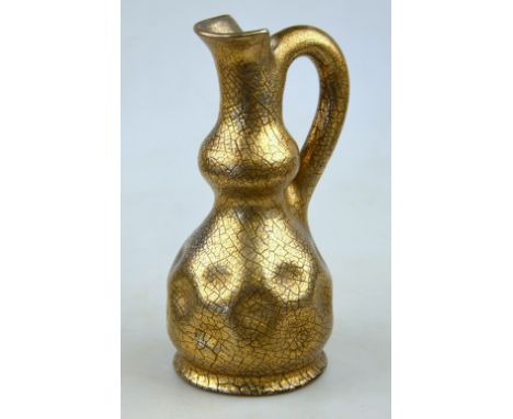 A Sunflower Pottery jug by Sir Edmund Elton, the dimpled body covered with a cracked metallic glaze over a brown ground, pain