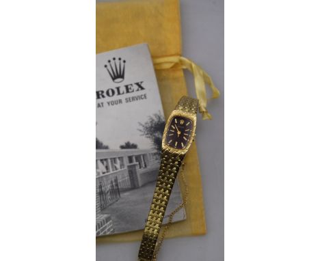 A lady's 14ct gold Rolex wristwatch with brown oblong dial and textured scale-link bracelet strap, import London 1973, with b