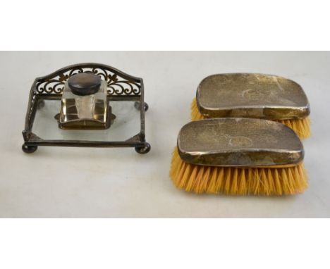 An Edwardian silver and glass ink stand with pierced gallery and square bottles, on bun feet; Birmingham 1905, to/w a pair of