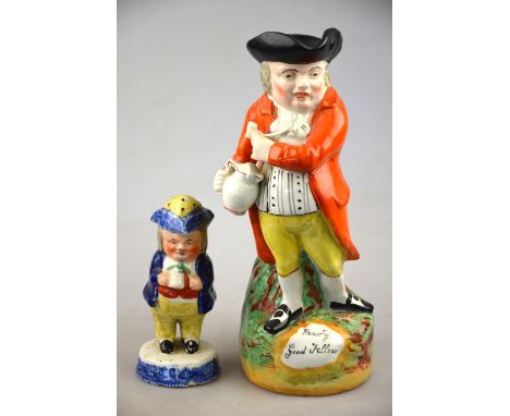 A Victorian Staffordshire 'Hearty Good Fellow' Toby jug, the standing figure with twisted body holding an ale jug and clay pi