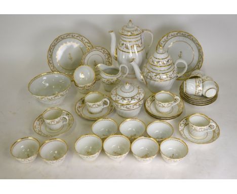 An extensive late 18th century/early 19th century fluted porcelain tea service decorated in gilt with an undulating leaf and 