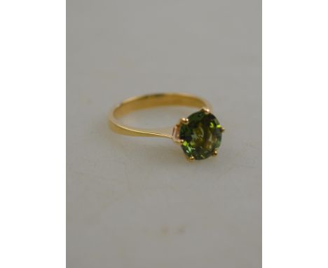 A single stone peridot ring, yellow metal set stamped 9ct, size M 1/2