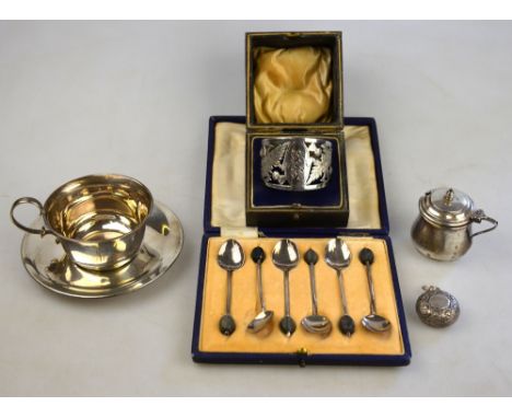 A silver cup and saucer, Sheffield 1924, to/w a cased napkin ring with thistle piercing, Sheffield 1921, a cased set of coffe