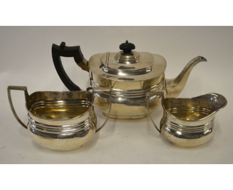 An Edwardian silver oblong three-piece tea service in the Georgian manner, Thomas Bradbury & Sons, London 1903/4, 31.6 oz