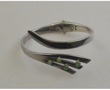 Sigi Taxco - A Mexican hinged white metal bangle set with four green cabochons, reputedly purchased from Liberty in 1969
