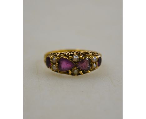 PLEASE NOTE - ALMANDINE GARNETS NOT AMETHYSTS A Victorian amethyst and seed pearl ring having two heart shaped amethysts to c