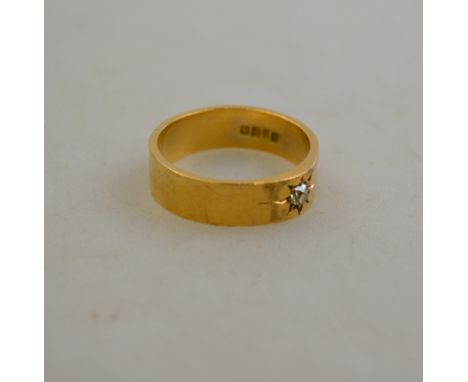 An 18ct yellow gold band ring set with cushion set diamond in gypsy style setting, size Z, approx 10g all in