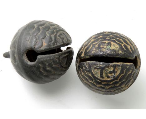 A matching pair of crotal bells bearing the initials FL, with fish scale decoration on the lower hemisphere and a sunburst pa