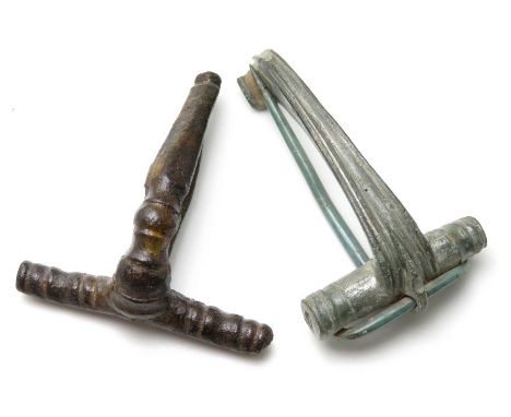 Two Roman Brooches  Circa, 1st-2nd century AD. Copper-alloy, 45mm & 39mm. Two T-shape bow brooches complete with original pin