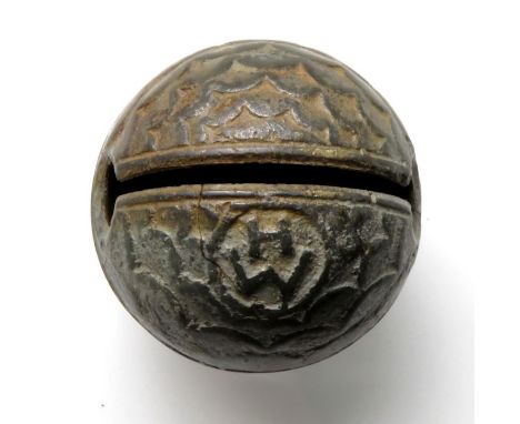 17th century crotal bell bearing the initials HW, with fish scale decoration on the lower hemisphere and a sunburst pattern o