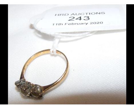 A three stone diamond ring in gold setting 