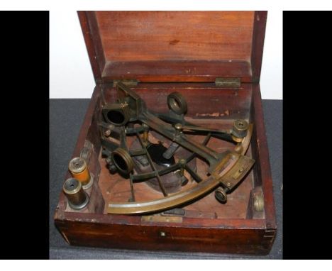 An antique sextant, the brass and silver scale with London maker's name, spare lenses and case 