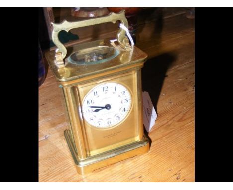 A brass cased carriage clock by Dimmer &amp; Son, Southsea - 12cm high 