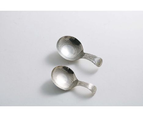 A GEORGE III SMALL CADDY SPOON with an engraved stem and scale-like pricking in the bowl, together with a similar larger cadd