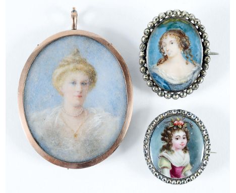 A MINIATURE PORTRAIT of a girl with flowers in her hair, oval, enamel on copper; 2.5 x 2.25 cms in paste set frame, a portrai