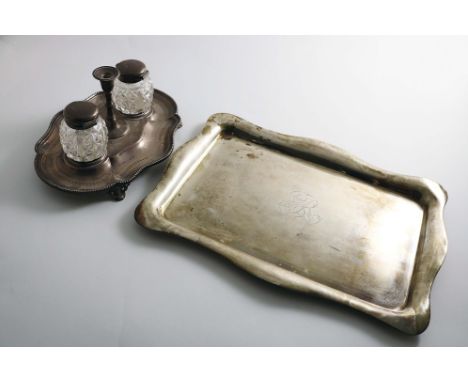 A SMALL VICTORIAN ENGRAVED INKSTAND of shaped oval outline with a central taperstick and two mounted cut-glass ink bottles by