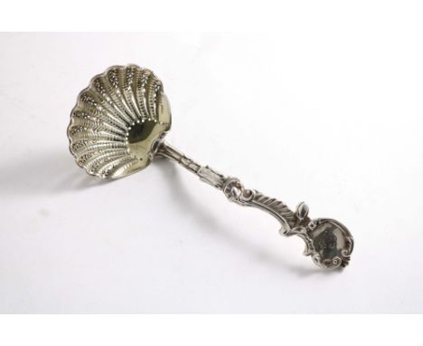 AN EARLY VICTORIAN CAST SUGAR SIFTER LADLE with a naturalistic stem, a cartouche terminal, crested, a scallop shell bowl with