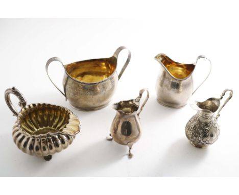 A GEORGE III ENGRAVED OVAL CREAM JUG initialled, &amp; a Victorian sugar basin to match it, by Charles Stuart Harris, London 