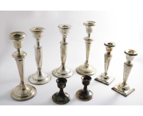 A PAIR OF SMALL EARLY 20TH CENTURY CANDLESTICKS  on square bases, by J &amp; R. Griffin, Chester 1913/14 and three other pair