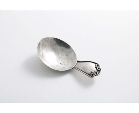 AN EARLY 20TH CENTURY ARTS &amp; CRAFTS CADDY SPOON the stem decorated with a wire border and two beads, by Amy Eleanor Stewa