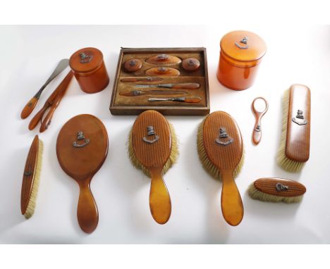 A LATE VICTORIAN MOUNTED BLONDE TORTOISESHELL DRESSING TABLE SET, TO INCLUDE:- a hand mirror, two hair brushes, two clothes b