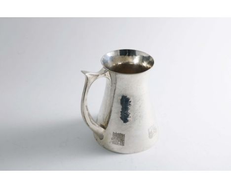 A LATE 20TH CENTURY HANDMADE MUG of conical form with a flared rim, a "spiked" handle and a hammered finish, engraved around 