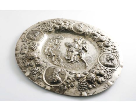 A LATE 19TH CENTURY GERMAN EMBOSSED OVAL DISH with fruit and portrait medallions around the sides and tranquil scene in the c