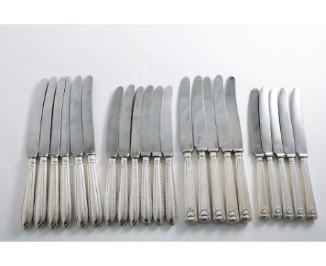 A SET OF SIX MID 20TH CENTURY TABLE KNIVES AND SIX SIDE KNIVES TO MATCH with pointed, bead pattern handles &amp; stainless st