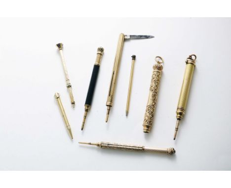 A SMALL COLLECTION OF PENCILS:- Eight various late 19th century / early 20th century, gold-plated examples to include:- A lar