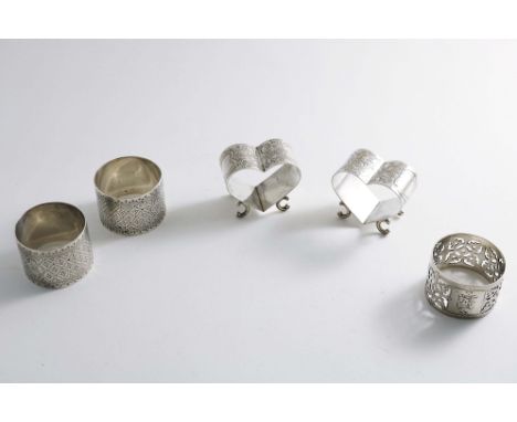 NAPKIN RINGS:- A pair of late Victorian heart-shaped napkin rings with engraving and scroll feet, by William H. Leather, Birm