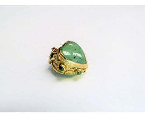 A gold pendant/charm with a heart shaped jade centre in scroll work mount, marks rubbed, 9.4g total 